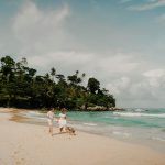 Romantic walk with a dog on a scenic tropical beach in Phuket, Thailand.