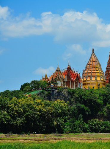 Stunning view of Wat Tham Suea temple in Thailand surrounded by lush greenery.
